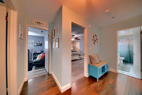 a view of a hallway with wooden floor