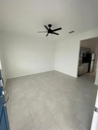 an empty room with a empty space and a ceiling fan