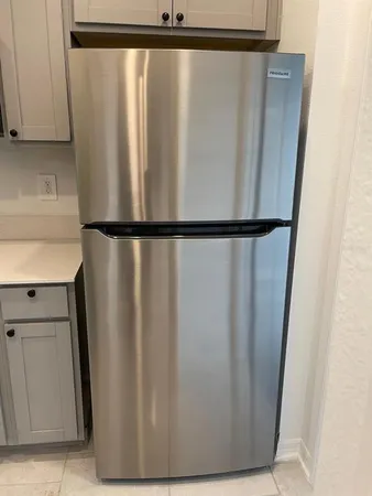 a view of a refrigerator in kitchen