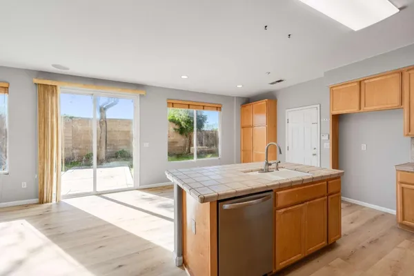 a room with a granite countertop sink and mirror