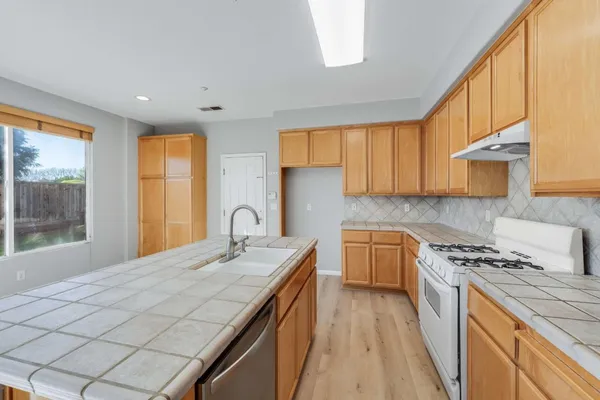 a kitchen with a sink stove and cabinets