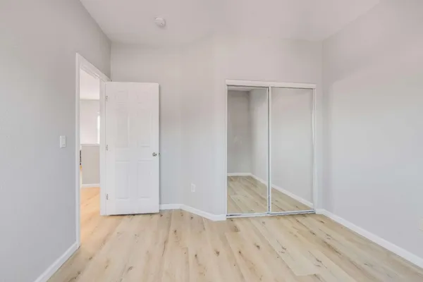 an empty room with wooden floor