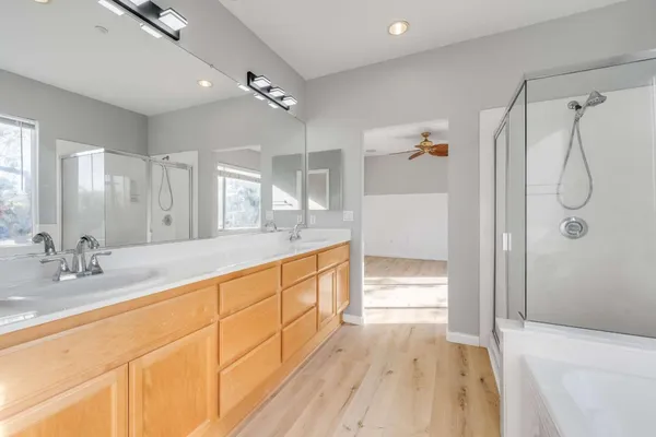 a bathroom with a double vanity sink and mirror