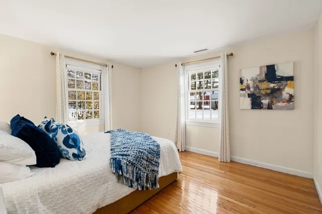 a bedroom with a large bed and a window