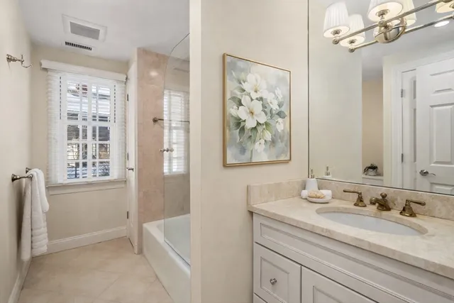 a bathroom with a tub sink and mirror