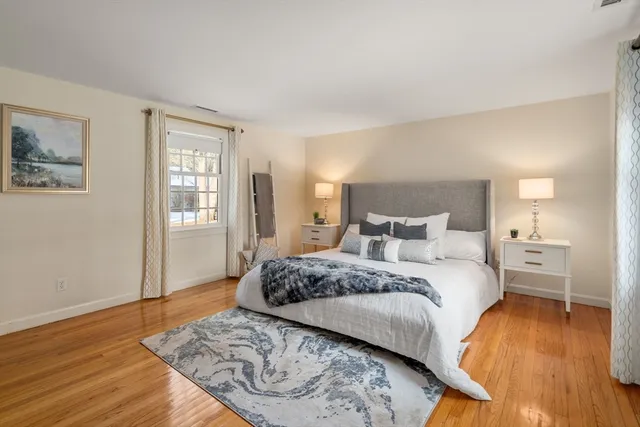 a bedroom with a bed and wooden floor