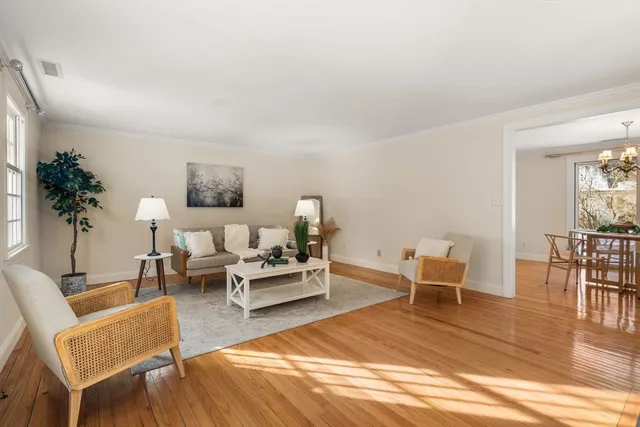a living room with furniture wooden floor and a table