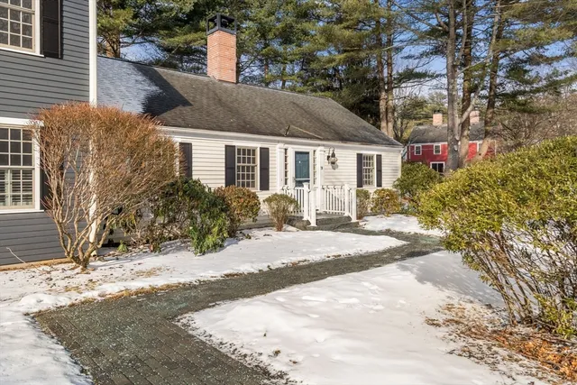 a view of a house with snow on the road