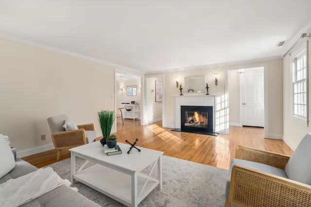 a living room with furniture a fireplace and a large window