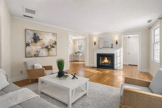 a living room with furniture a fireplace and a window