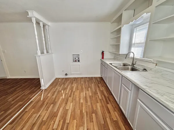 a kitchen with sink and refrigerator