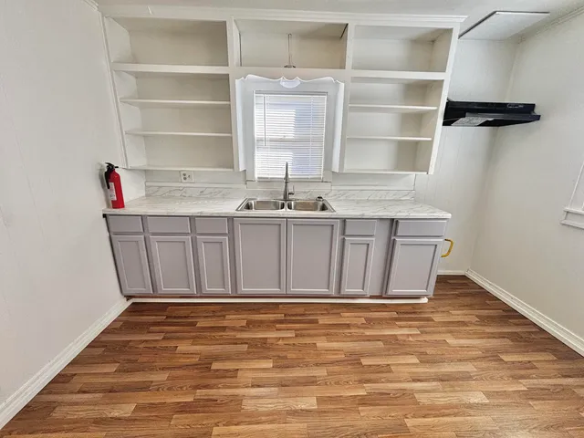 a view of a kitchen with a sink and cabinets