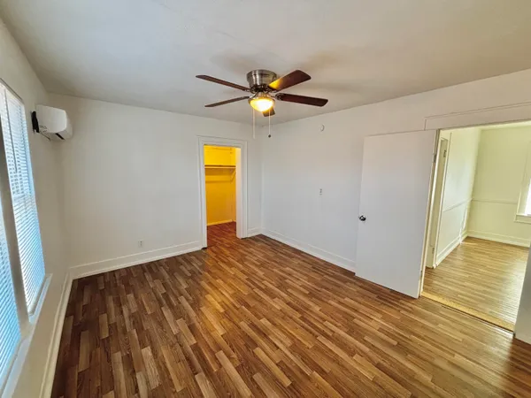 a view of empty room with wooden floor