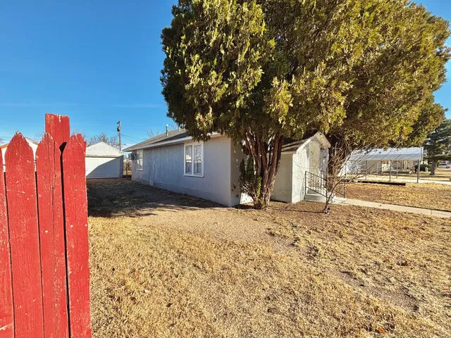 a backyard of a house with wooden fence