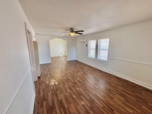 wooden floor in an empty room with a window