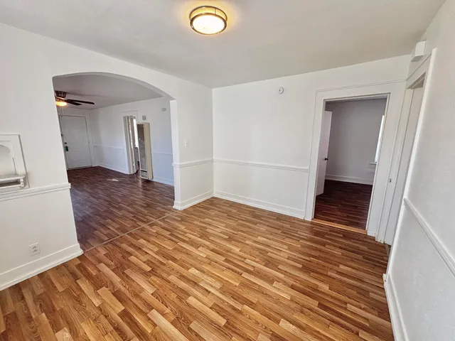 a view of a room with wooden floor and cabinet