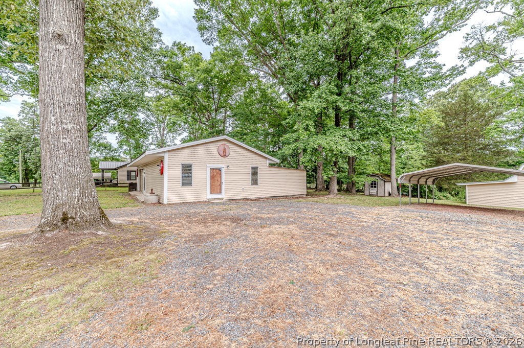 3384 Goldston Glendon Road Goldston, NC 27252 - Photo 39 of 47 a view of a house with a yard and large trees