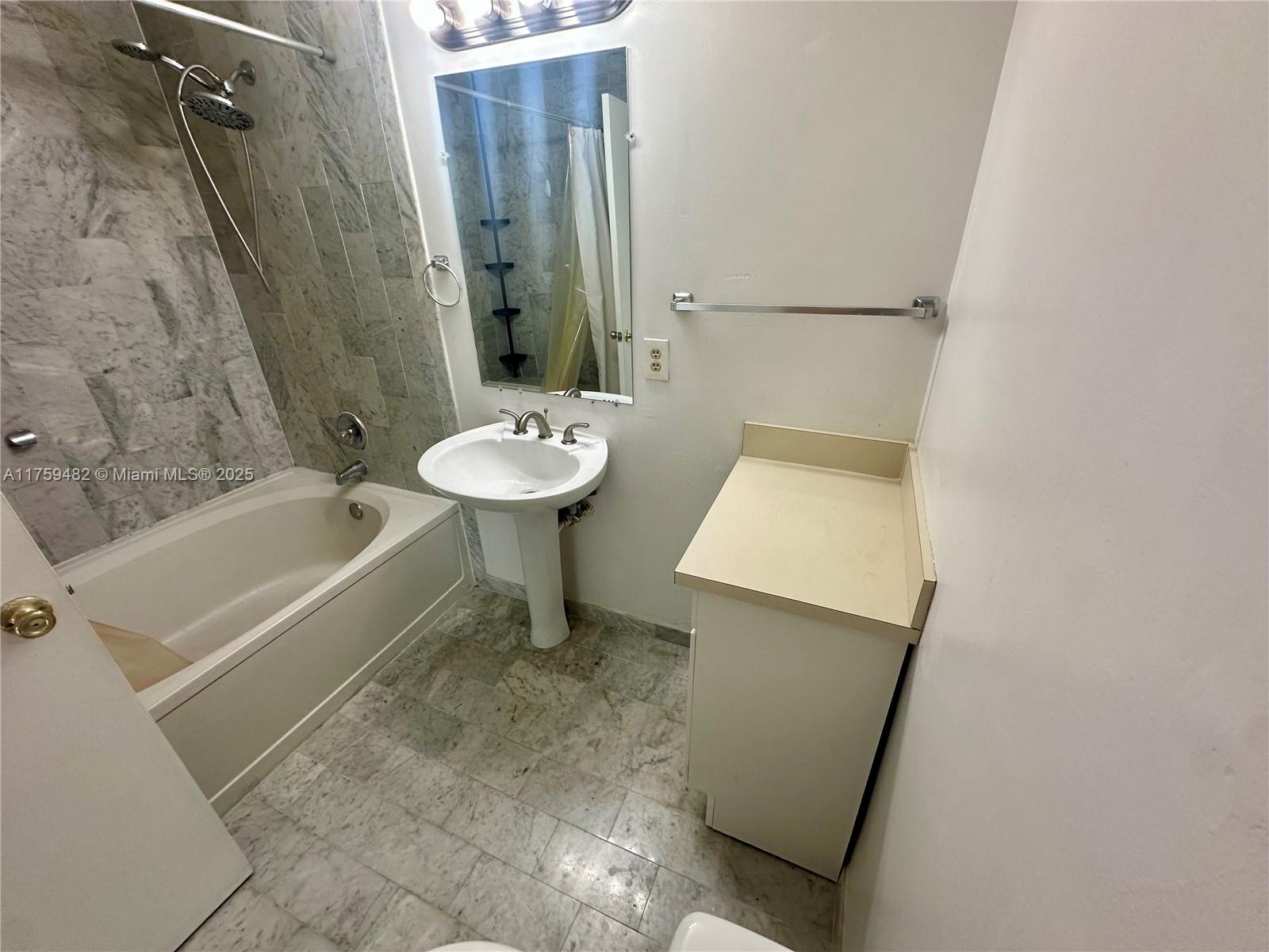 10023 Southwest 77th Court Miami, FL 33156 - Photo 12 of 22 a bathroom with a sink a toilet and shower