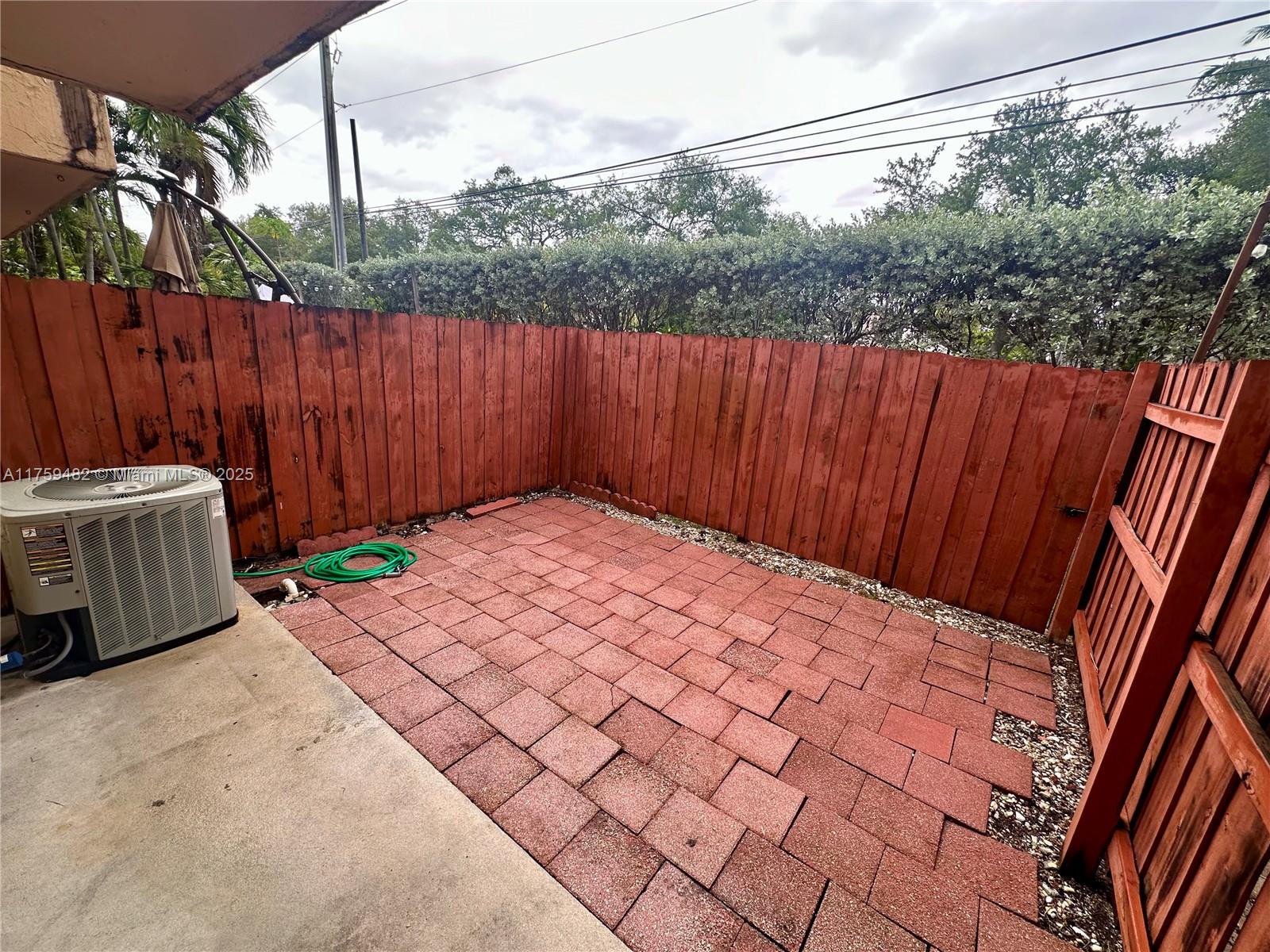 10023 Southwest 77th Court Miami, FL 33156 - Photo 16 of 22 a backyard of a house