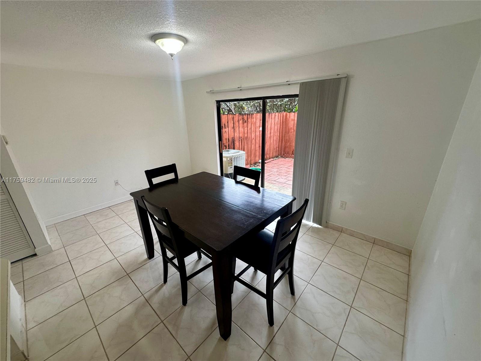10023 Southwest 77th Court Miami, FL 33156 - Photo 18 of 22 a view of a dining room with furniture