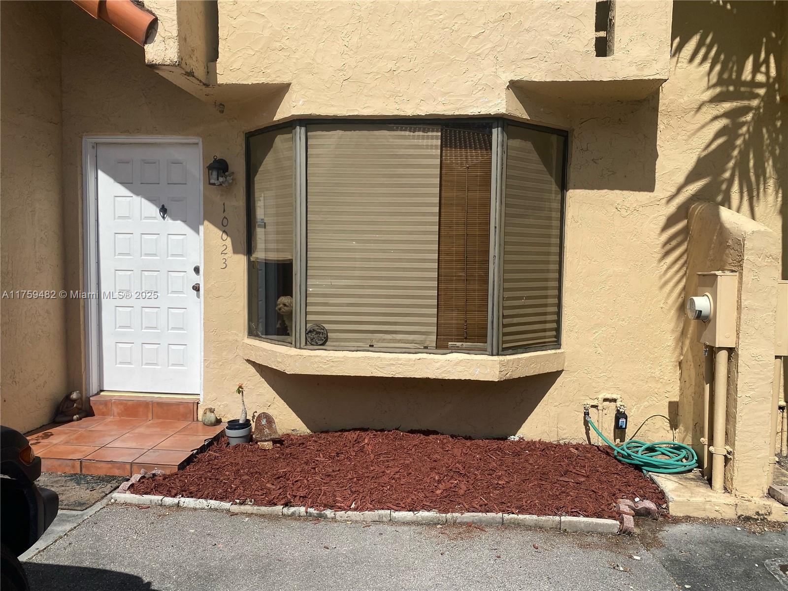 10023 Southwest 77th Court Miami, FL 33156 - Photo 19 of 22 a view of a house with a patio