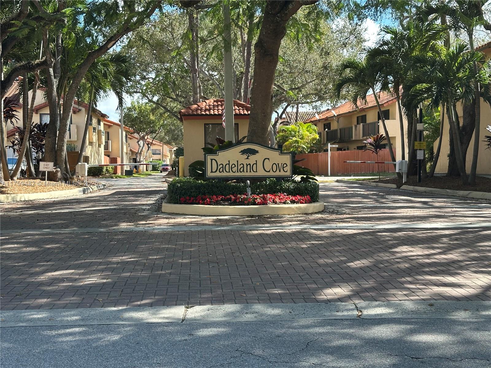 10023 Southwest 77th Court Miami, FL 33156 - Photo 20 of 22 a front view of a building with street