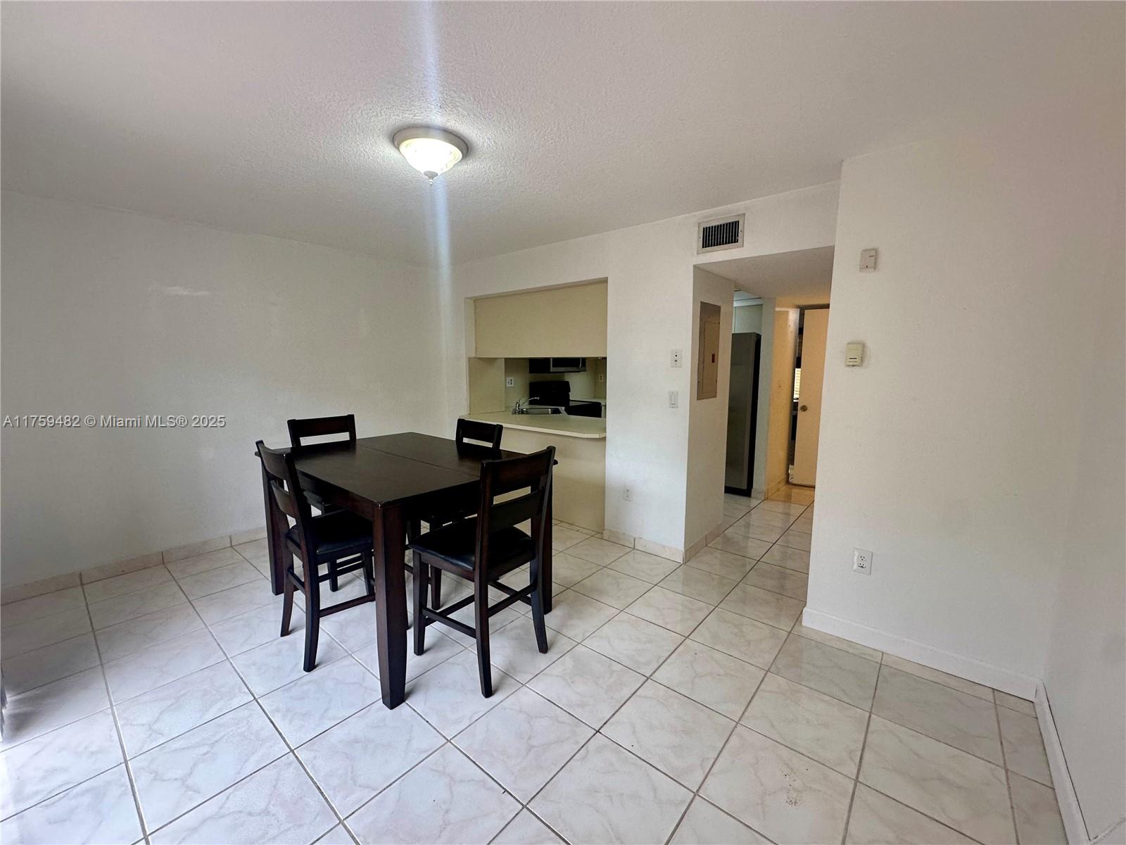 10023 Southwest 77th Court Miami, FL 33156 - Photo 4 of 22 a view of a dining room with furniture