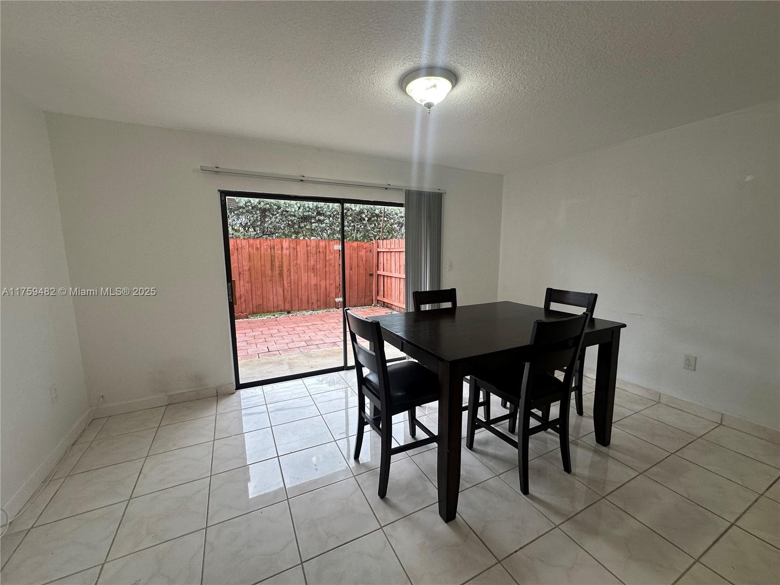 10023 Southwest 77th Court Miami, FL 33156 - Photo 5 of 22 a view of a dining room with furniture and window