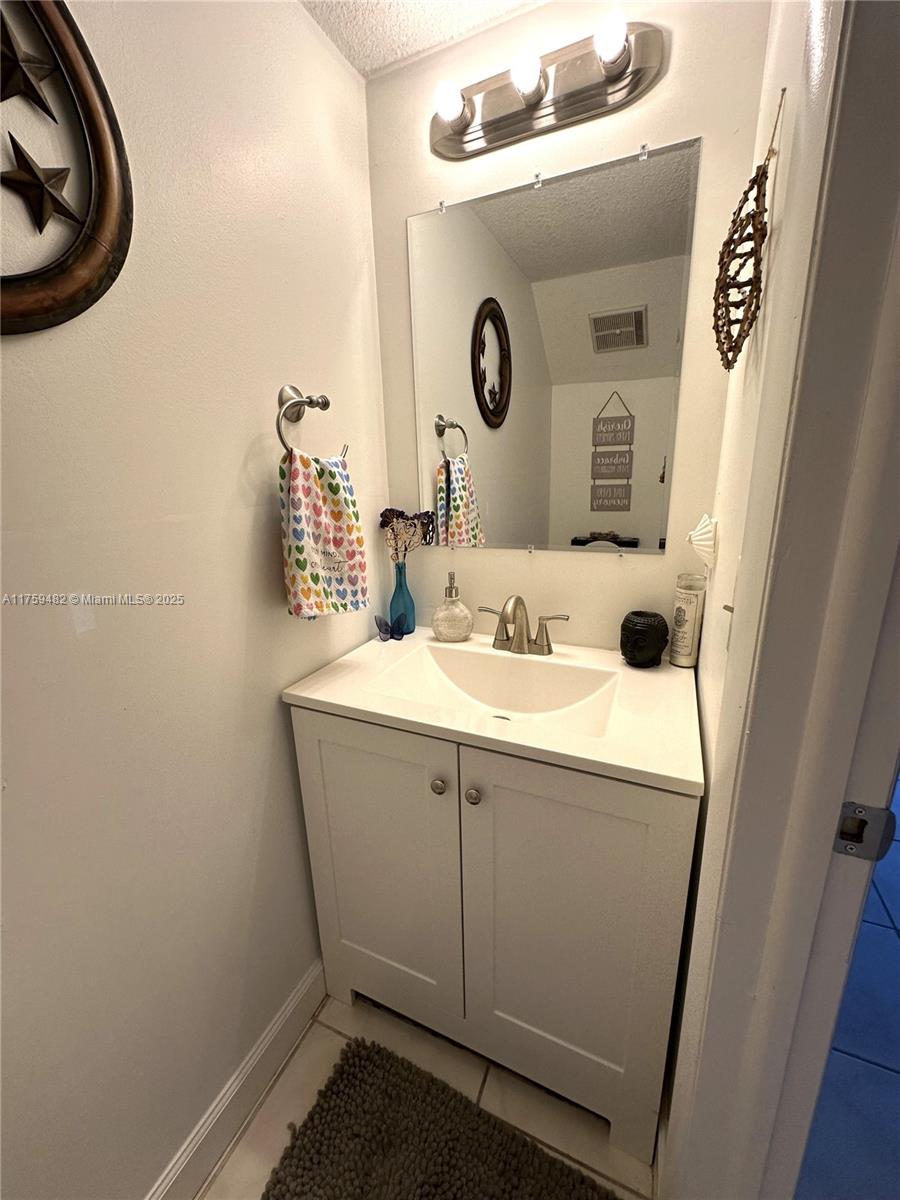 10023 Southwest 77th Court Miami, FL 33156 - Photo 9 of 22 a bathroom with a sink and a mirror