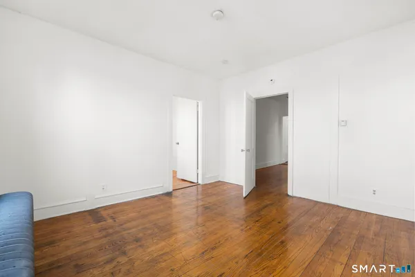 a view of an empty room with wooden floor
