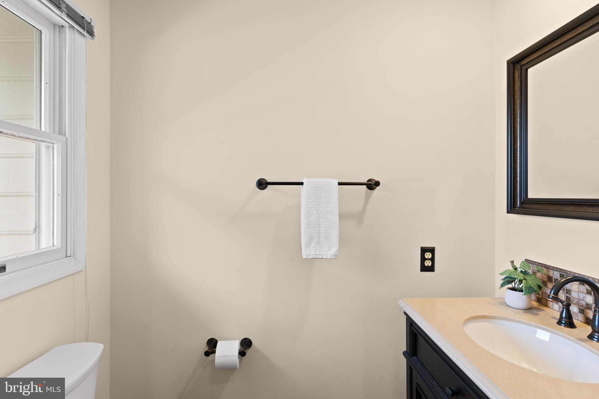 7823 Sabre Court Manassas, VA 20109 - Photo 11 of 39 a bathroom with a sink and a mirror