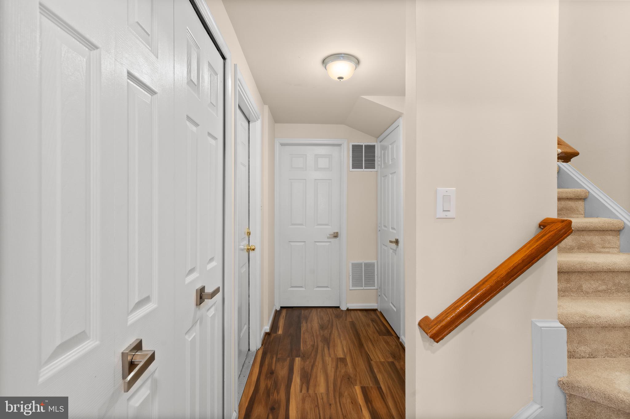 7823 Sabre Court Manassas, VA 20109 - Photo 38 of 39 a view of a hallway with wooden floor and staircase