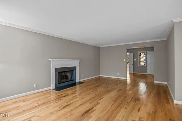 a view of empty room with window and fireplace