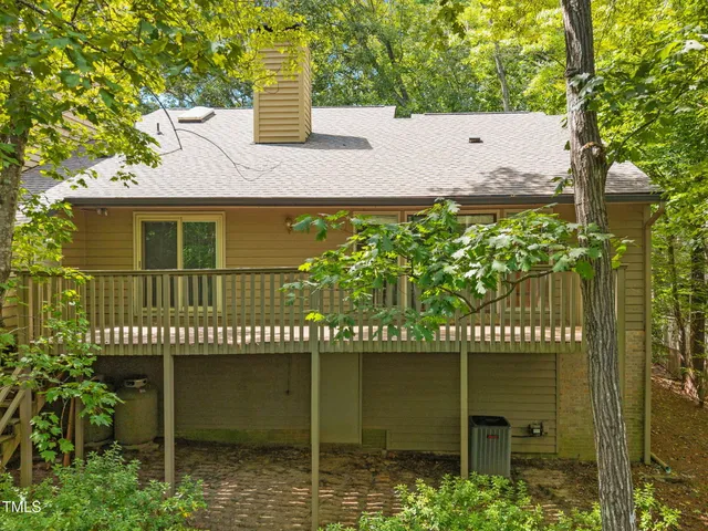 a view of backyard with deck and wooden floor