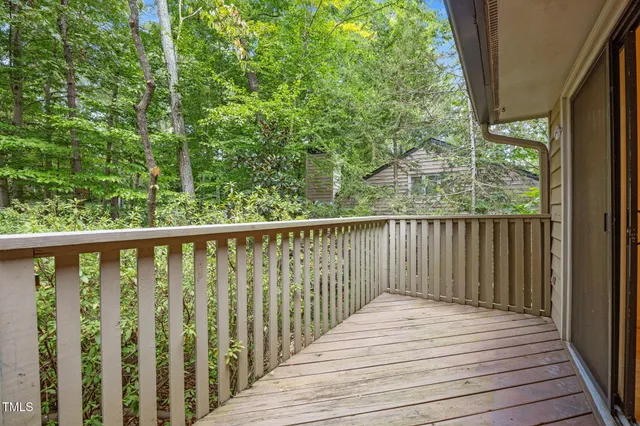 a balcony with wooden floor and fence