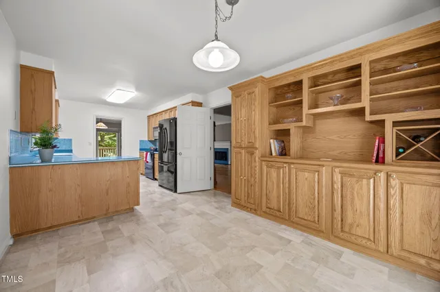 a view of kitchen with furniture and refrigerator