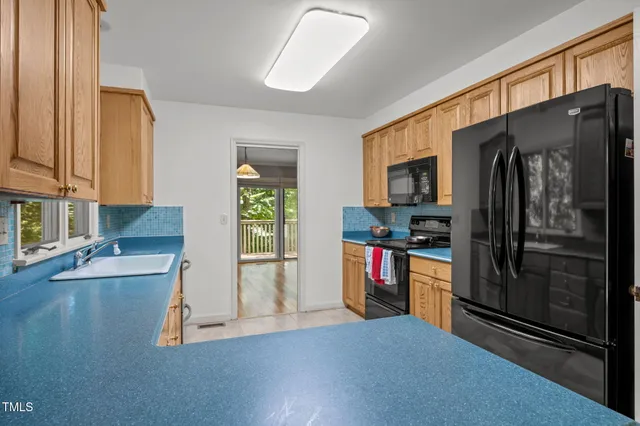a kitchen with stainless steel appliances granite countertop a refrigerator and a sink