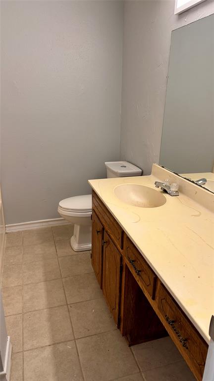 3812 Stuart Road Denton, TX 76209 - Photo 6 of 9 a bathroom with a sink a toilet and a mirror