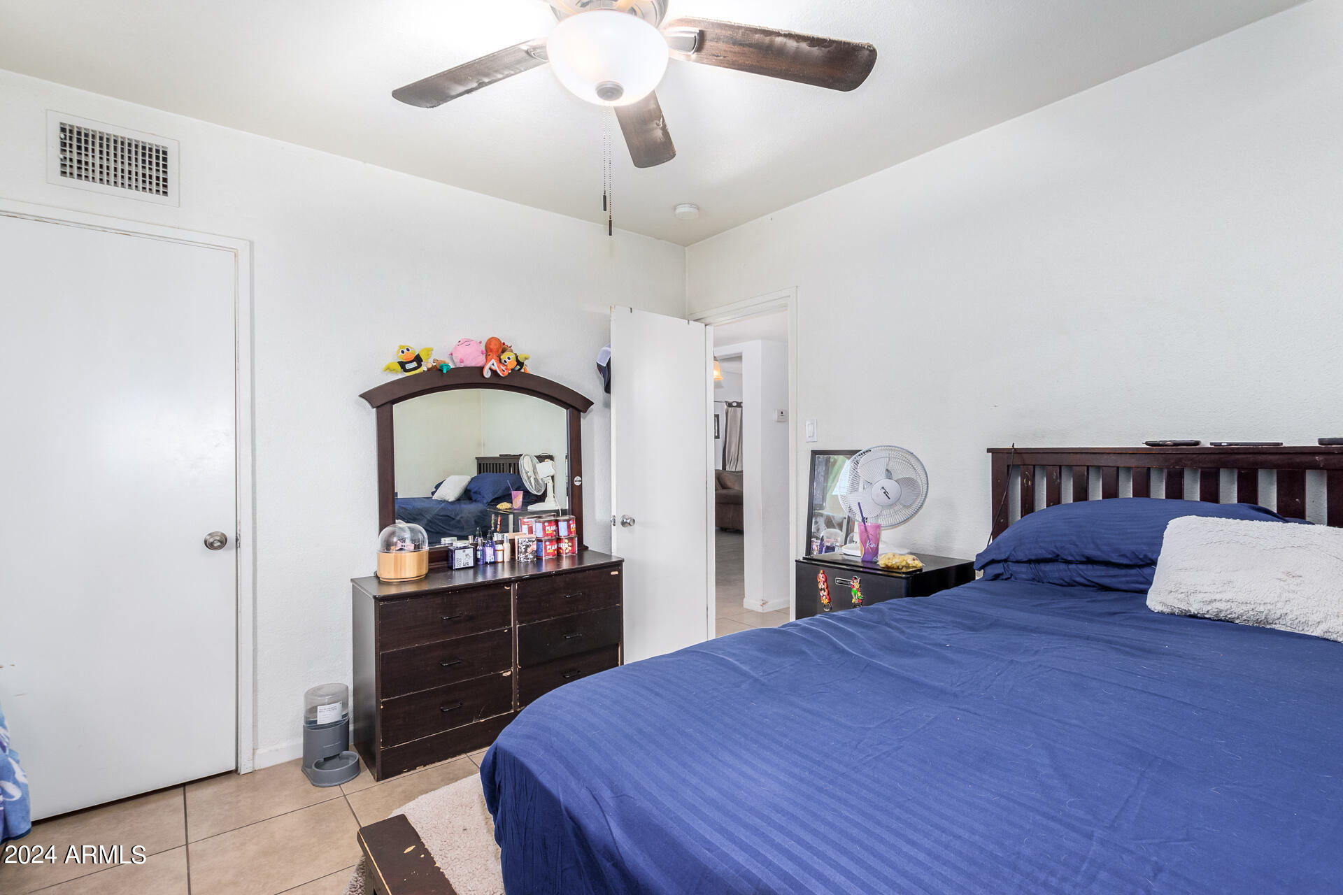 3845 North 15th Avenue Phoenix, AZ 85015 - Photo 11 of 28 a bedroom with a bed and a dresser