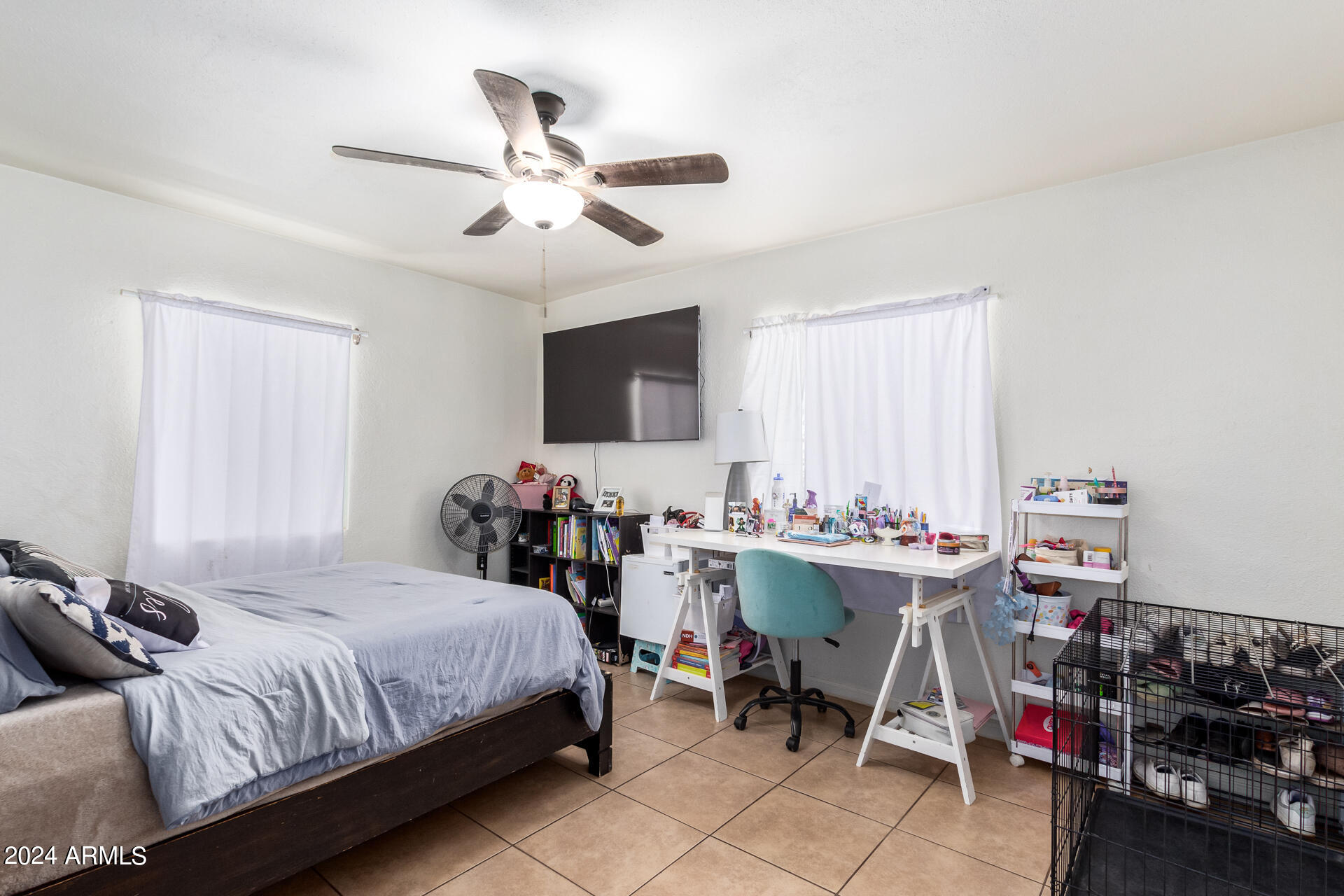3845 North 15th Avenue Phoenix, AZ 85015 - Photo 13 of 28 a bedroom with a bed and a chandelier