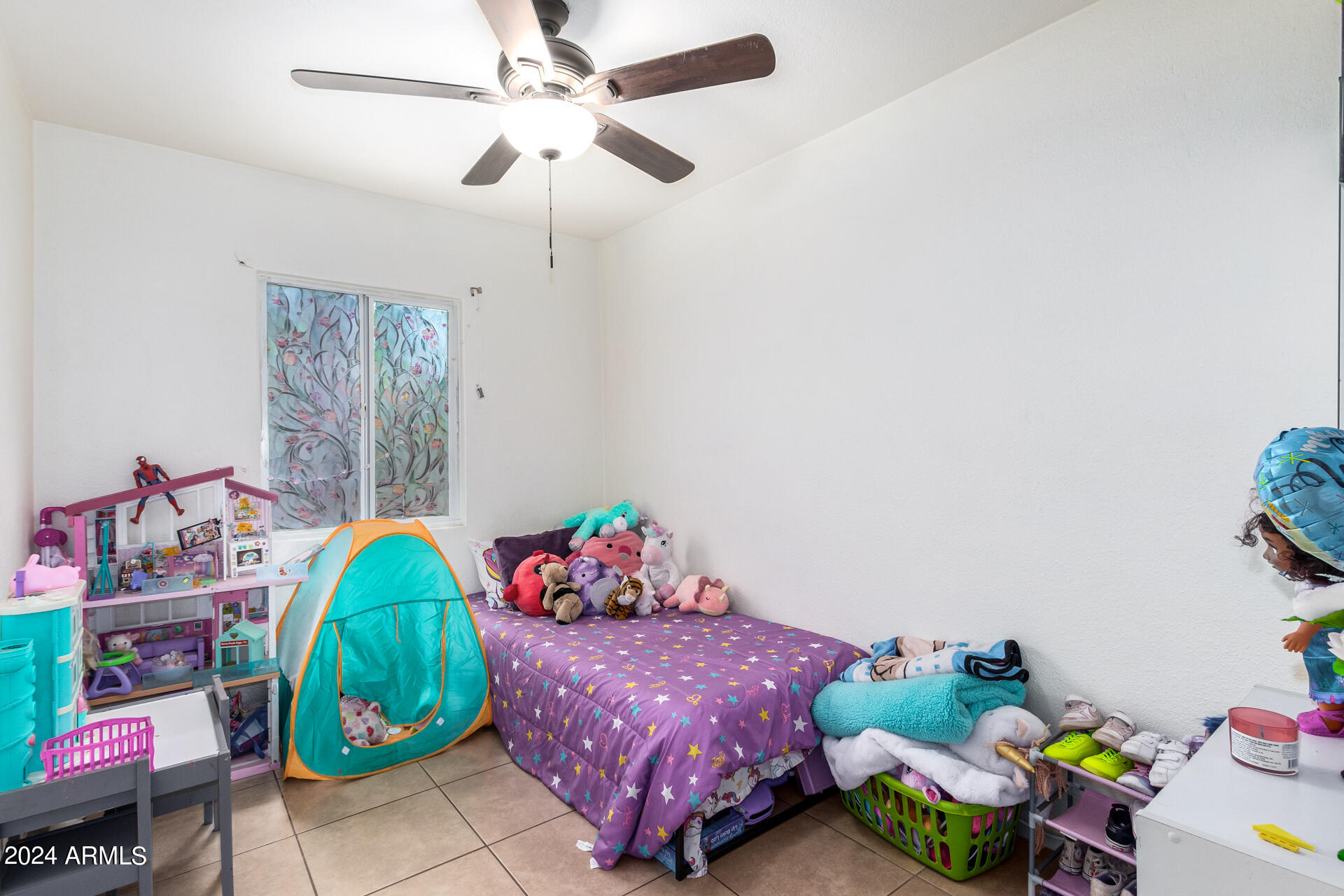 3845 North 15th Avenue Phoenix, AZ 85015 - Photo 15 of 28 a bedroom with a bed and a window