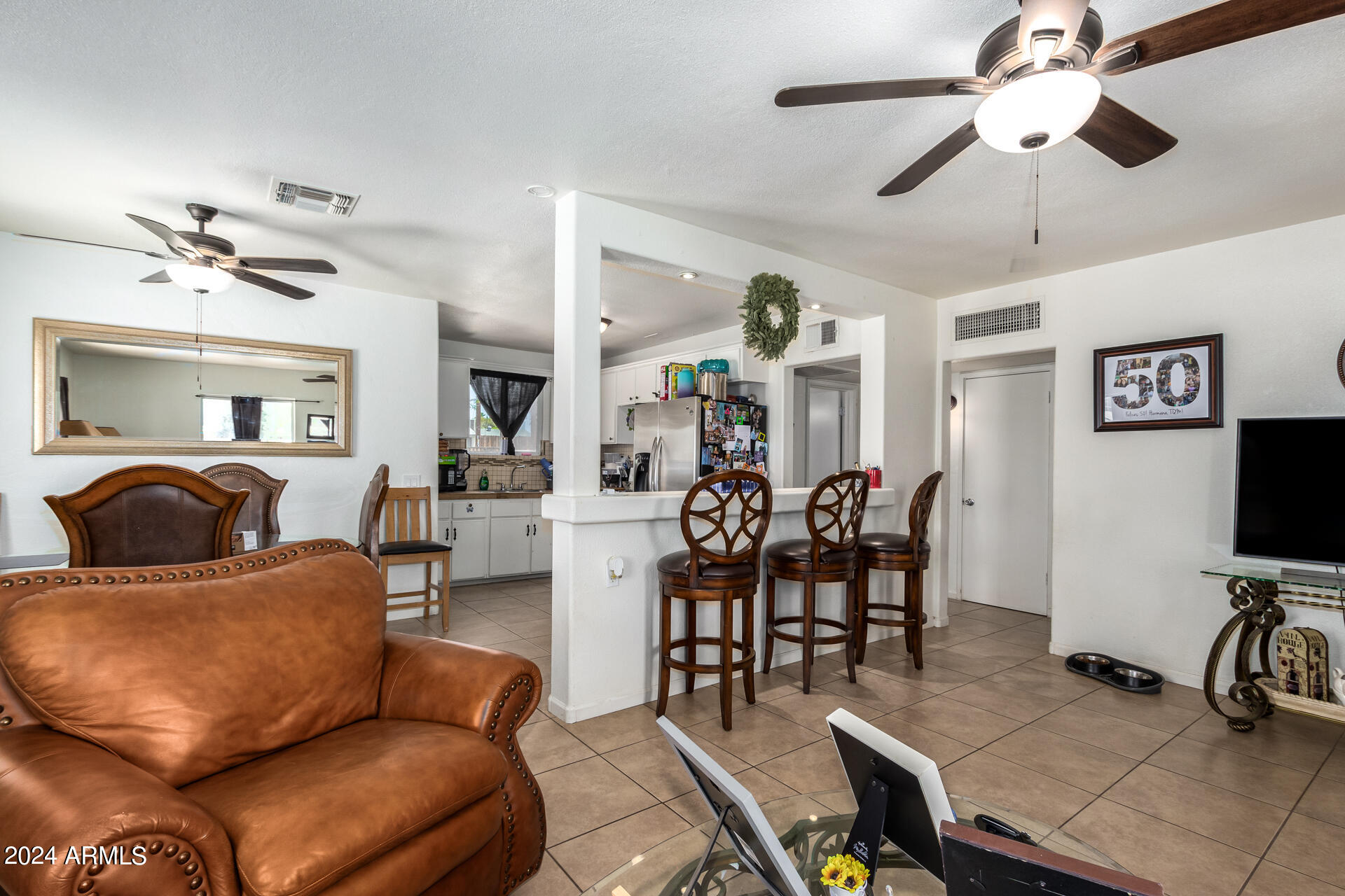 3845 North 15th Avenue Phoenix, AZ 85015 - Photo 2 of 28 a living room with furniture and a flat screen tv