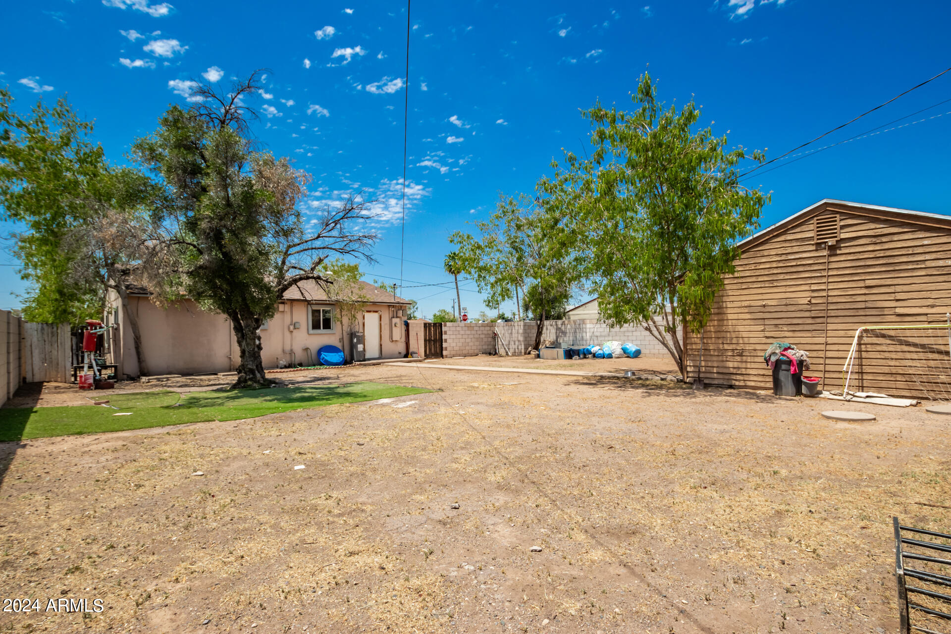 3845 North 15th Avenue Phoenix, AZ 85015 - Photo 26 of 28 a view of a house with backyard and tree s