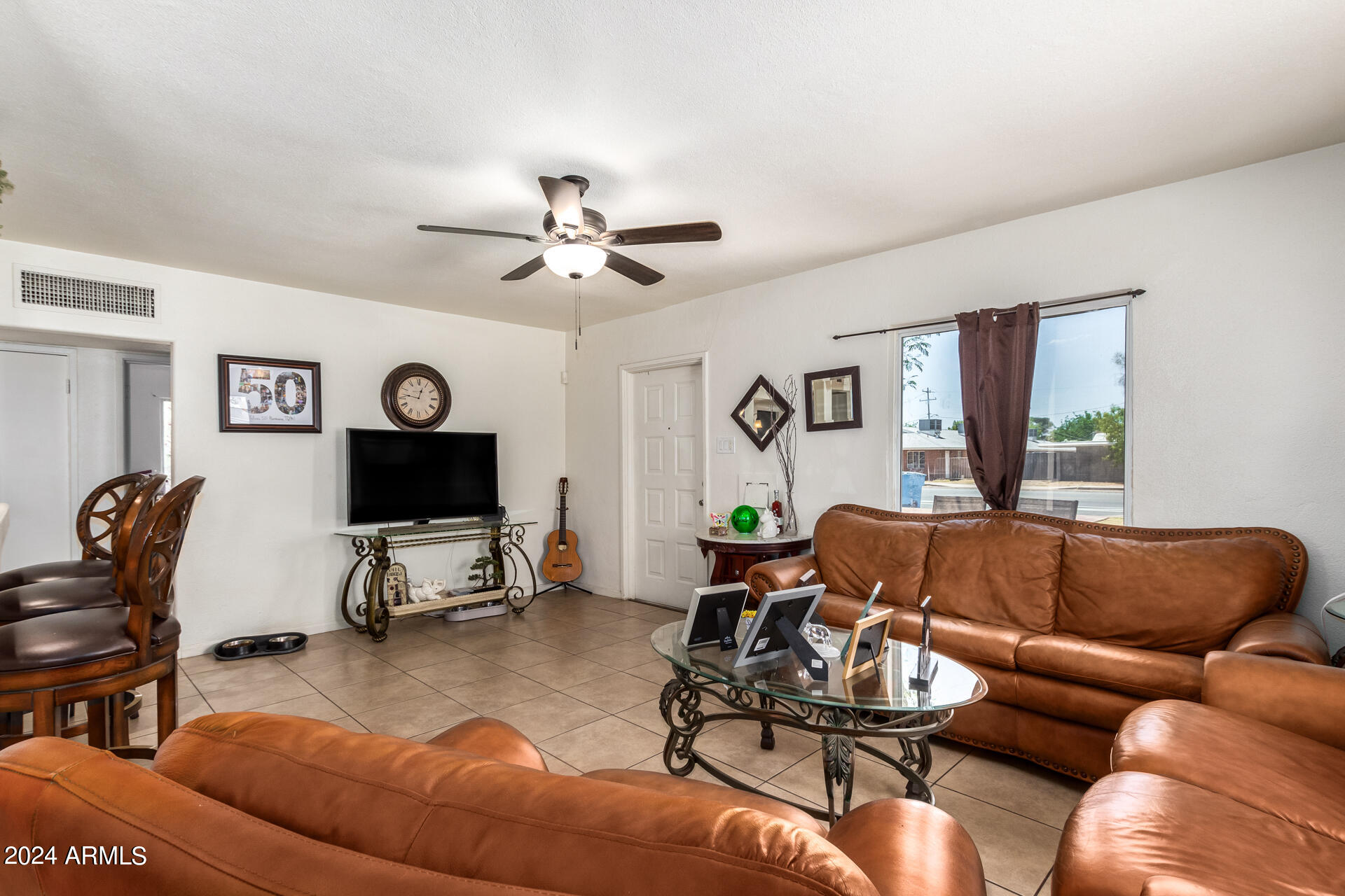 3845 North 15th Avenue Phoenix, AZ 85015 - Photo 3 of 28 a living room with furniture a couch and a window