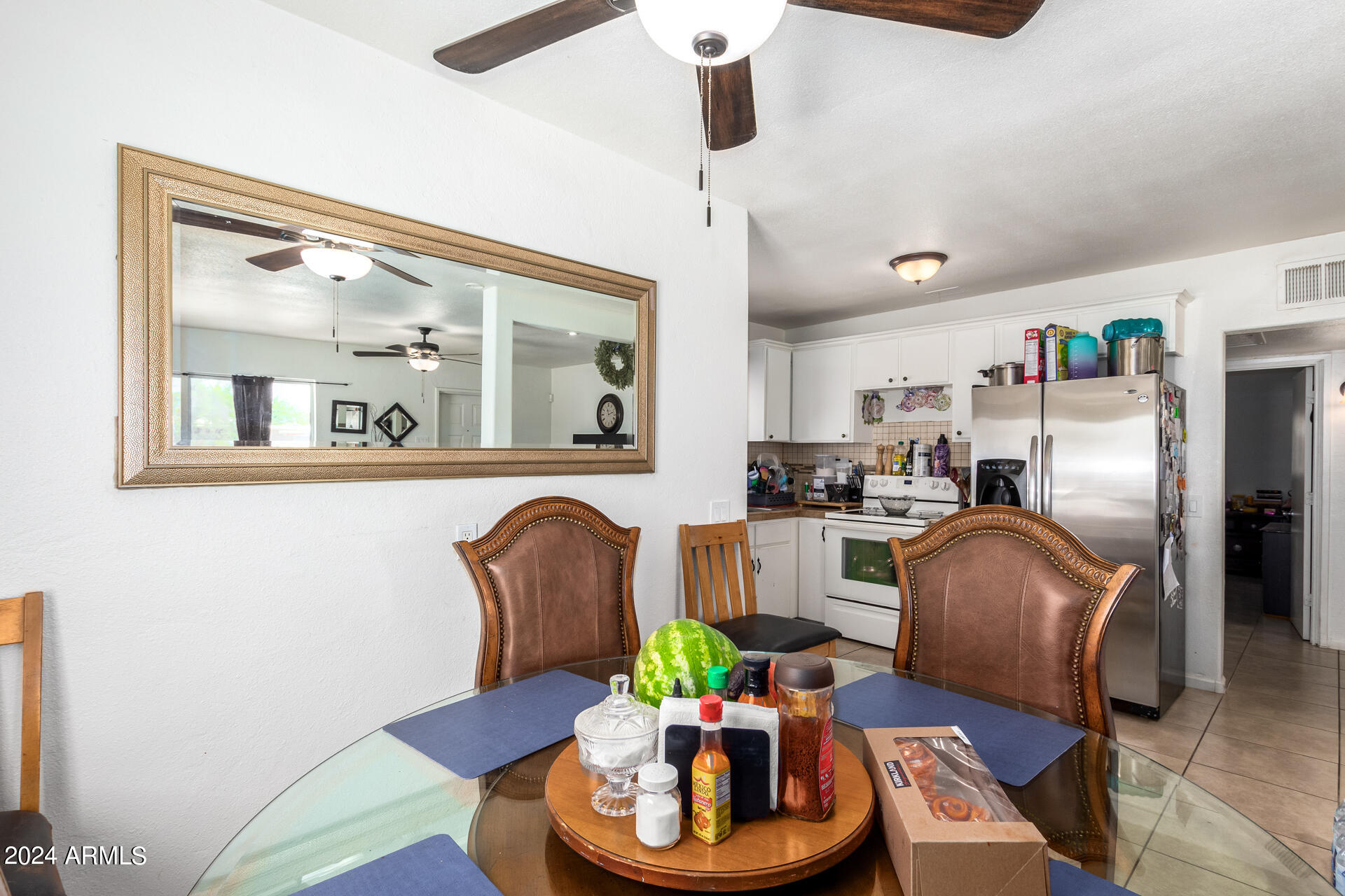3845 North 15th Avenue Phoenix, AZ 85015 - Photo 5 of 28 a living room with furniture and a chandelier