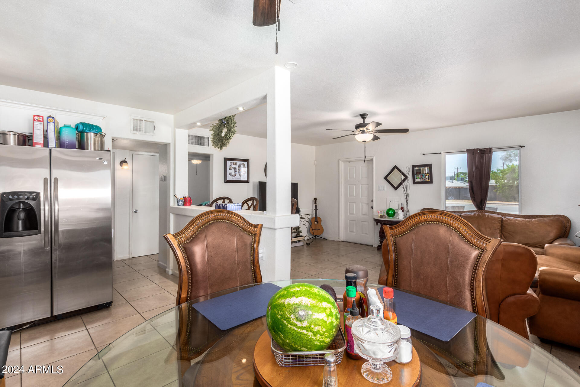 3845 North 15th Avenue Phoenix, AZ 85015 - Photo 6 of 28 a living room with furniture and a chandelier
