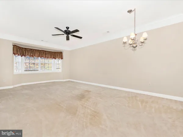 a view of a kitchen with a sink and a chandelier fan