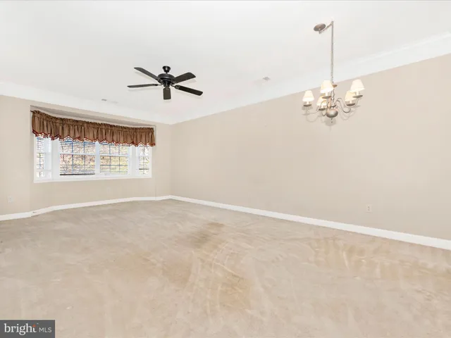 a view of a kitchen with a sink and a chandelier fan