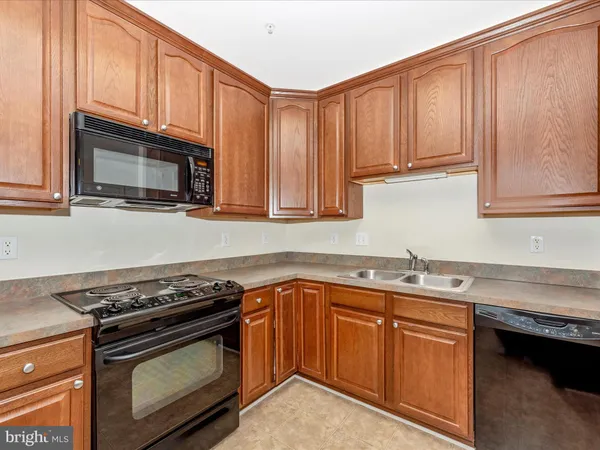 a view of a refrigerator in kitchen and wooden floor