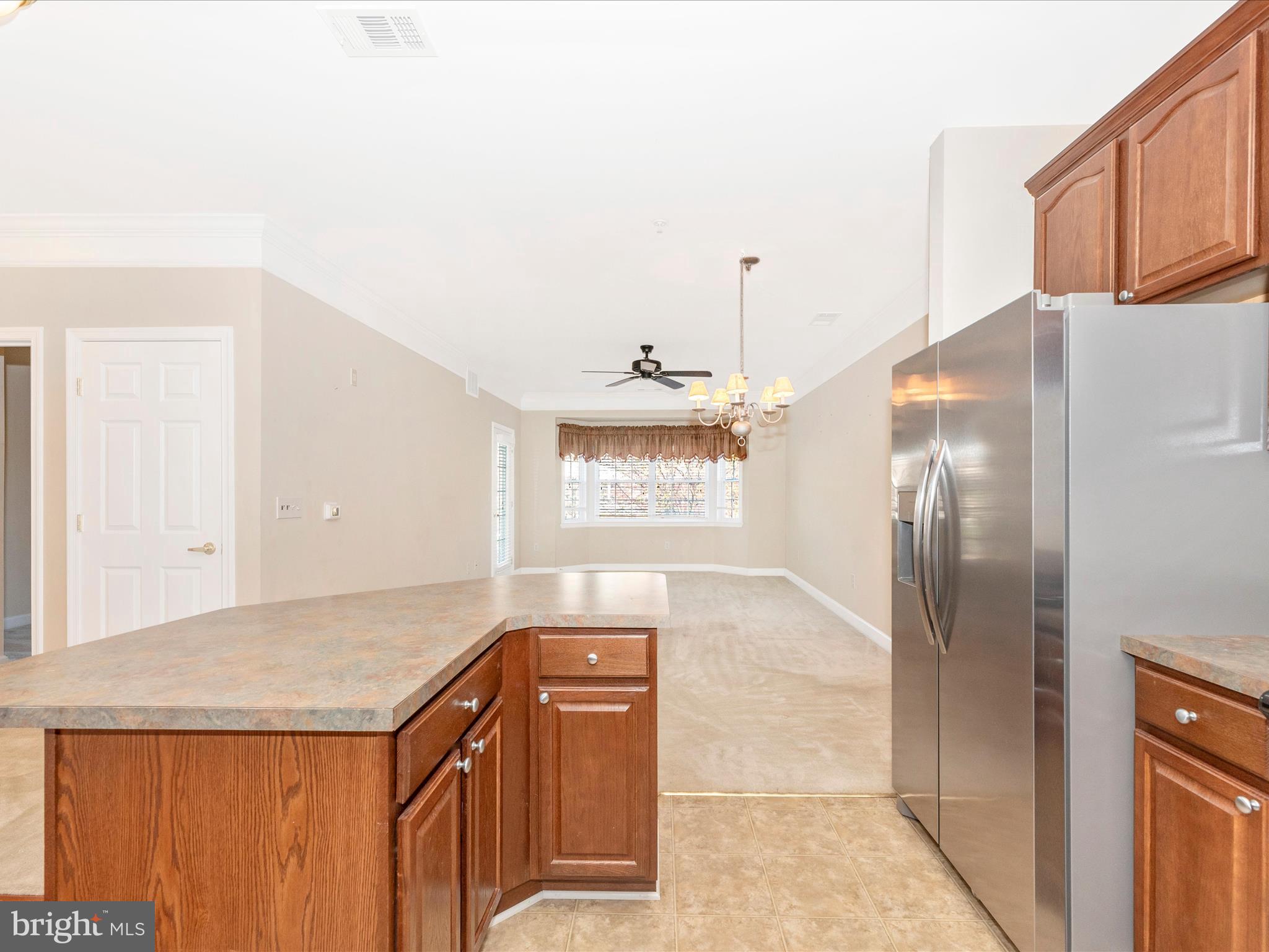 120 Burgess Hill Way, Unit 207 Frederick, MD 21702 - Photo 25 of 67 a view of a refrigerator in kitchen and wooden floor